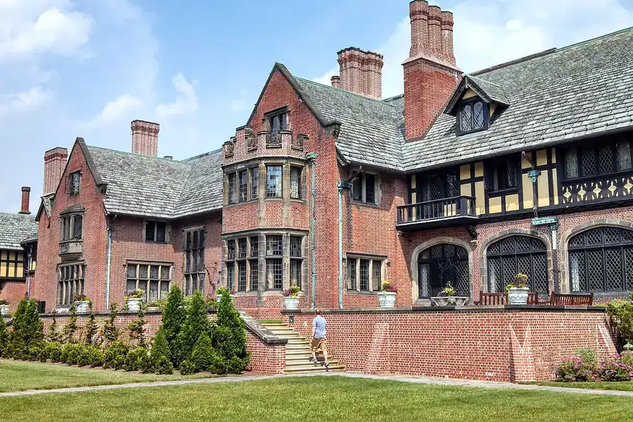 Tudor Revival Stan Hywet Hall with brick chimneys and a stone terrace in Akron, Ohio