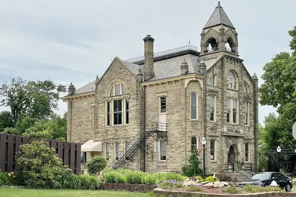 Amherst City Hall, an 1884 sandstone building with a bell tower, in Amherst, Ohio