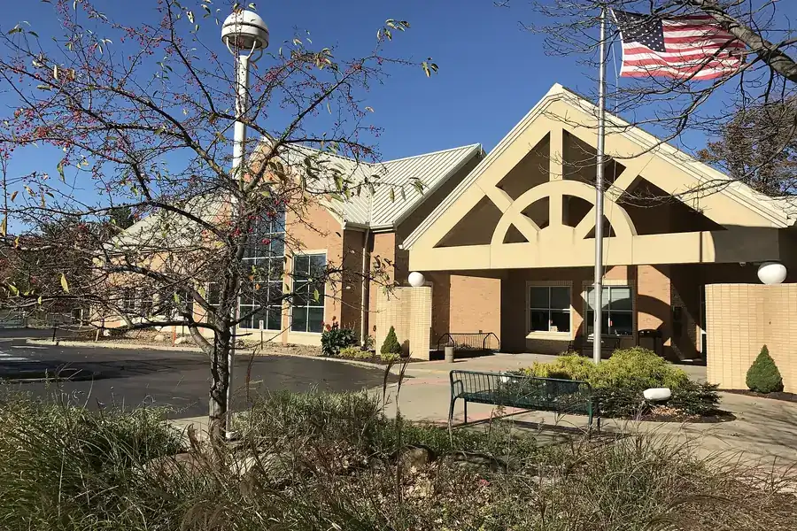 Avon Lake Public Library entrance with a flagpole and landscaped walk in Avon Lake, Ohio