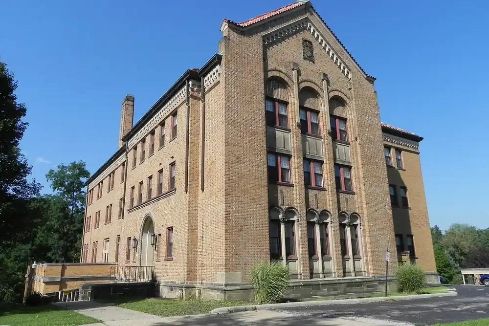 Brick Villa San Bernardo building with arched windows under a blue sky in Bedford, Ohio