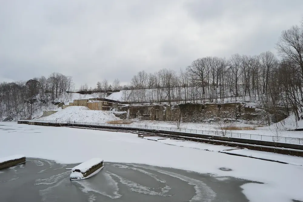 Snowy riverbank and the frozen Cuyahoga River seen from the Front Street bridge, Cuyahoga Falls, Ohio