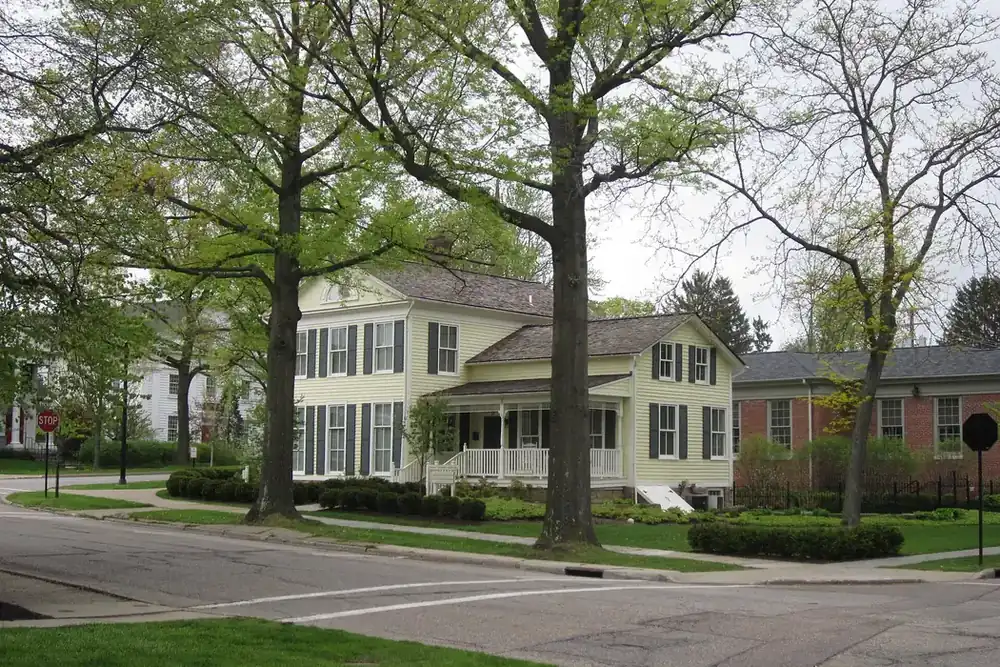Tree-lined street corner with historic clapboard houses in Hudson, Ohio