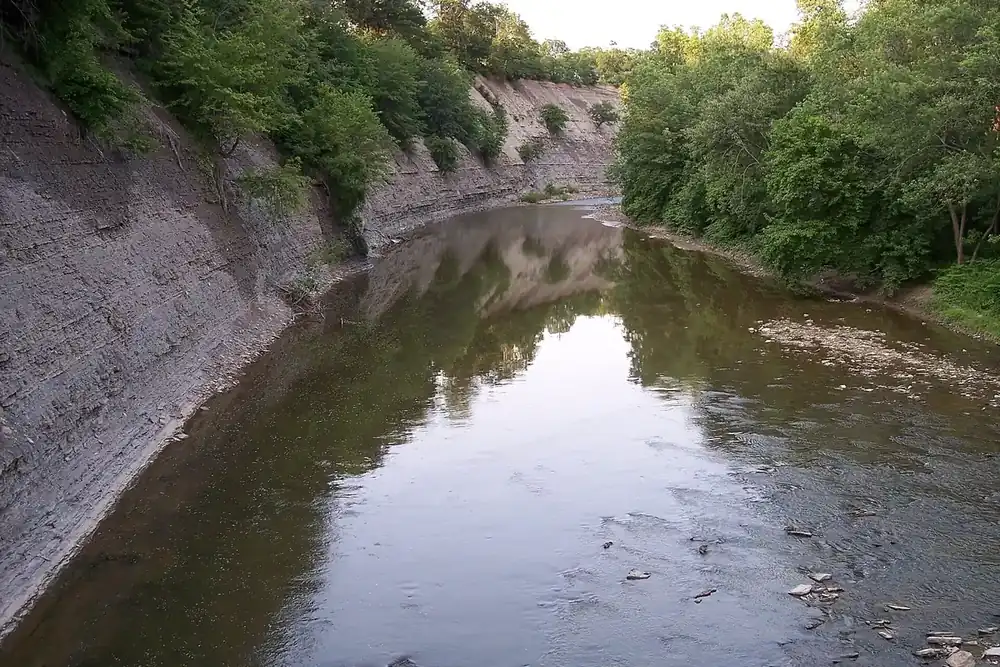 The Rocky River flowing between shale cliffs and green woods in Lakewood, Ohio