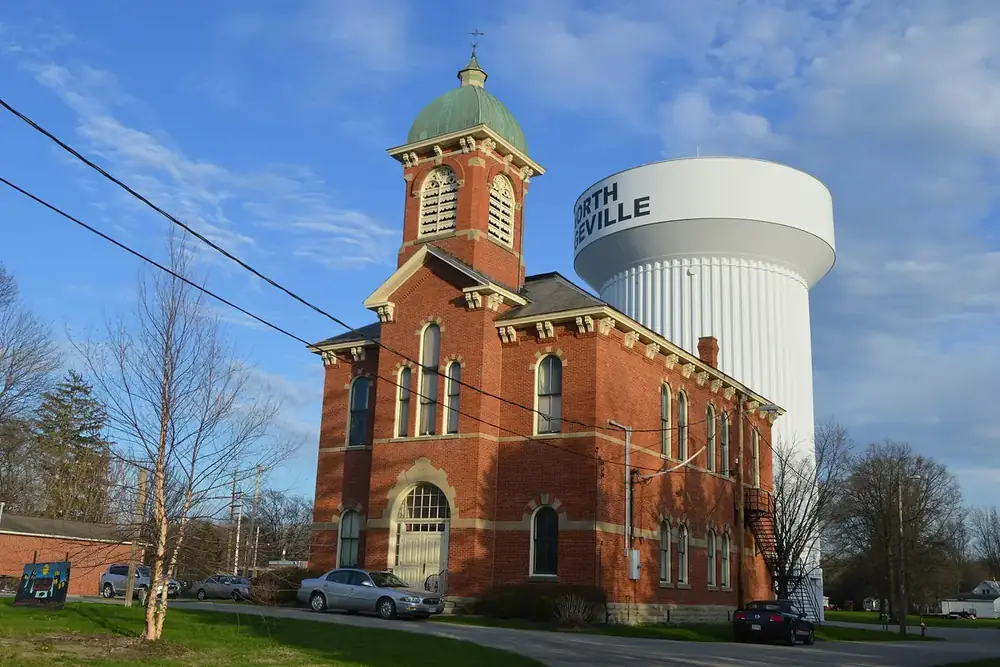 Brick North Ridgeville City Hall and its bell tower beside the city water tower, Ohio