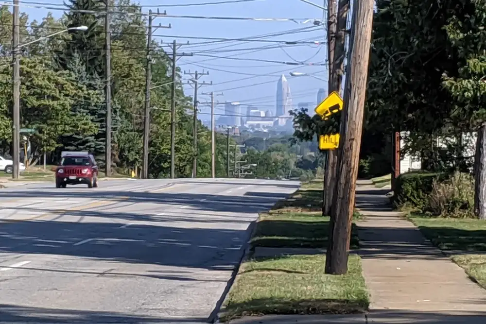 Tree-lined State Road with a distant view of the Cleveland skyline from Parma, Ohio