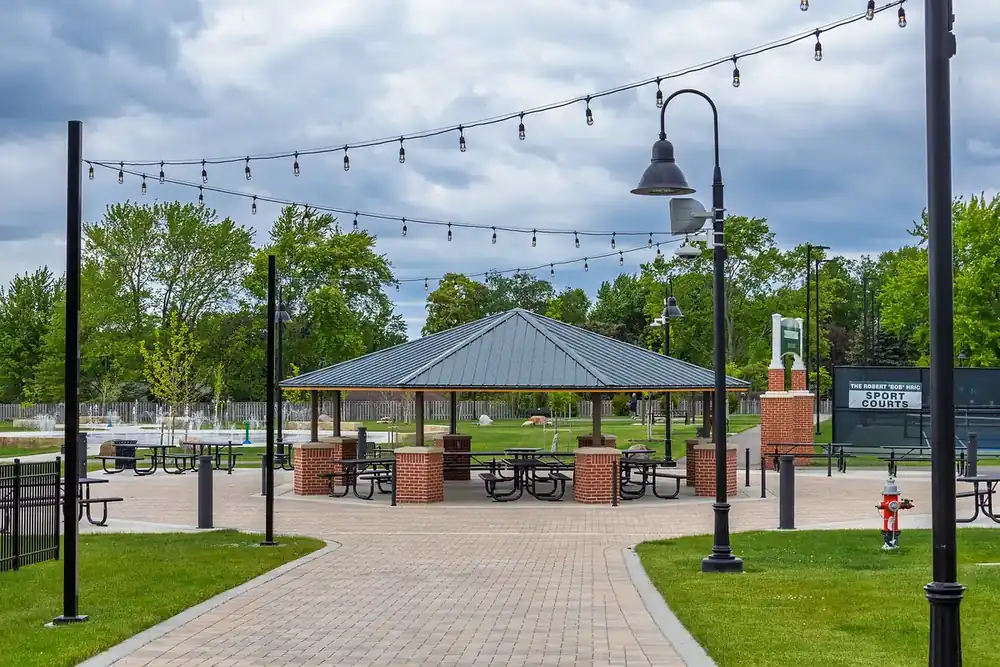 Brick plaza and picnic pavilion under string lights at Town Center Park in Strongsville, Ohio