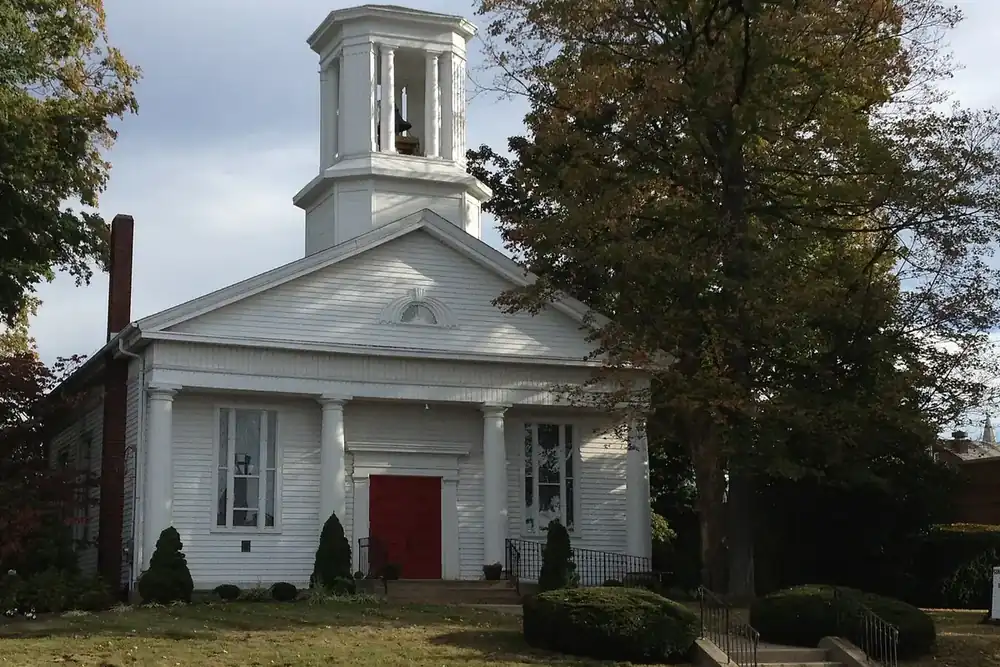White clapboard church with a bell tower under autumn trees in Wadsworth, Ohio